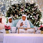 Shri Swami Vichar Purananand Ji Maharaj, accompanied by his followers, is providing Darshan (spiritual sight) to devotees during a ceremony at Anand Ashram