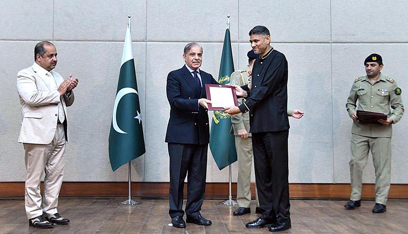 Prime Minister Muhammad Shehbaz Sharif distributing appreciation certificates among the staff of the PM House and PM Office