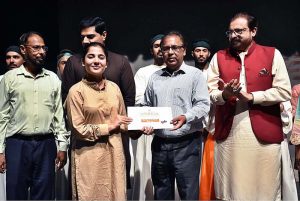 Artist Mohsin Gillani giving the certificates to the Arts students after completing one month workshop and performing on the stage during a Theater play titled (Apne Madad Aap) Directed by Rukhsana Khan and written by Syed Zeeshan in collaboration with Lahore Arts Council at Al-Hamra