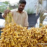 A vendor selling dates at his road side setup
