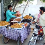 Vendor selling dates to a customer on a roadside