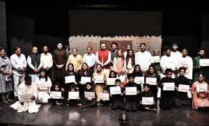 Artist Mohsin Gillani giving the certificates to the Arts students after completing one month workshop and performing on the stage during a Theater play titled (Apne Madad Aap) Directed by Rukhsana Khan and written by Syed Zeeshan in collaboration with Lahore Arts Council at Al-Hamra