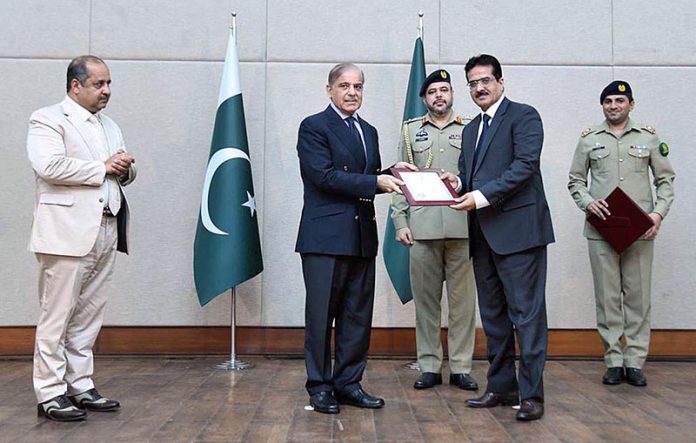 Prime Minister Muhammad Shehbaz Sharif distributing appreciation certificates among the staff of the PM House and PM Office