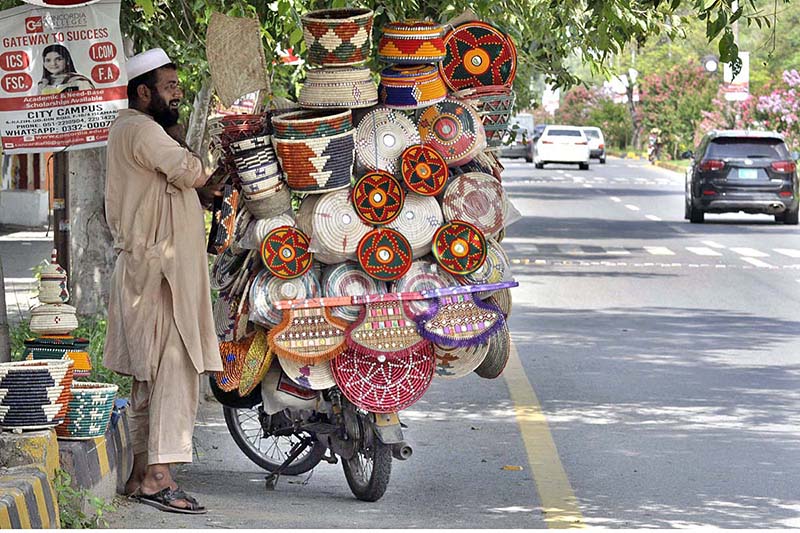 A street vendor displaying hand-made domestic use items to attract customers at roadside