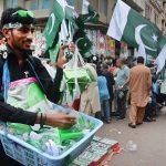 A vendor is selling National flags and badges at Paper Market in connection with of Independence Day