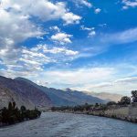 An attractive view of thick clouds hovering over the mountains and river