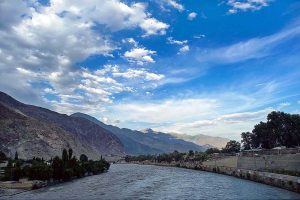 An attractive view of thick clouds hovering over the mountains and river