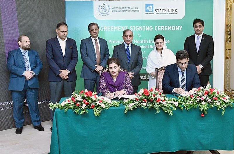 Director General, Directorate of Electronic Media Publications Ms. Samina Farzin and Divisional Head of State Life Insurance Corporation Mr. Muhammad Ashar signing MoU for provision of health insurance to artists and technicians associated with Pakistan's film industry. Prime Minister Shehbaz Sharif and Information Minister Ms Marriyum Aurangzeb witnessing the ceremony