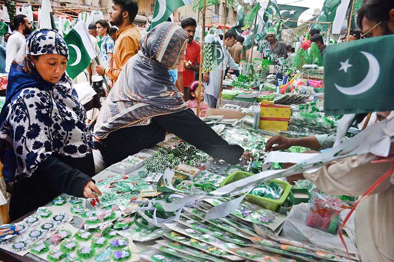 A vendor is selling National flags and badges at Paper Market in connection with of Independence Day