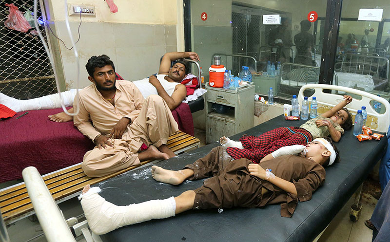Doctors are providing medical assistance to the injured patients during the rescue operation after the tragic incident where 10 bogies of the Hazara Express derailed near Sarhari Railway Station, at least 15 passengers have lost their lives and over 50 have been injured, including women and children