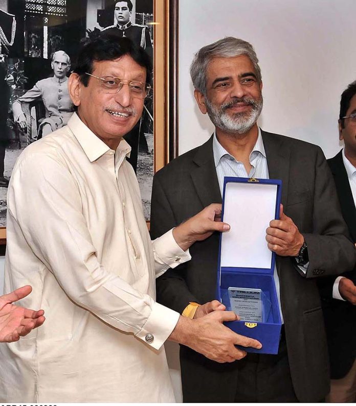 Federal Minister for IT and Telecommunication Syed Amin Ul Haque giving away souvenir to MD NTC Engr. Miraj Gul during inauguration ceremony of NTC SIEM Solution at NTC (National Telecommunication Corporation) Headquarters