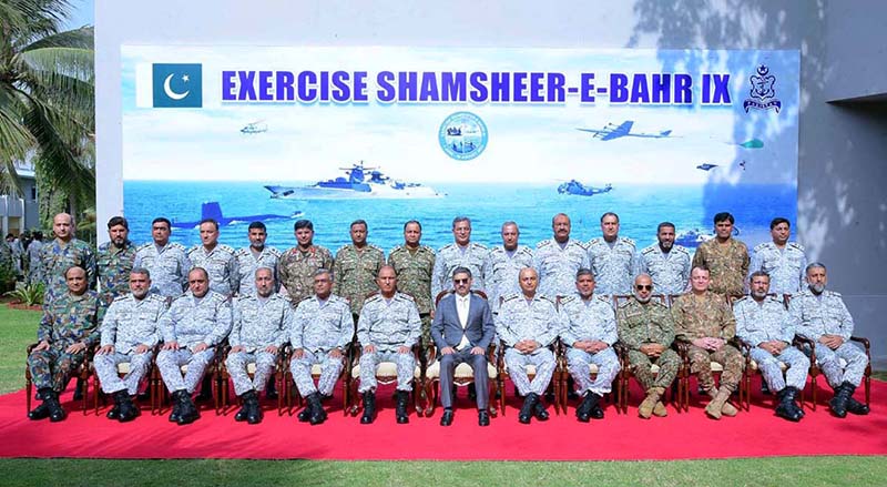 Caretaker Prime Minister Anwaar-ul-Haq Kakar in a group photo with Chief of the Naval Staff Admiral Amjad Khan Niazi, senior officers of tri-services and participants of Pakistan Navy war game "Shamsheer-e-Bahr IX"