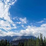 An attractive view of thick clouds hovering over the sky and mountain of the city