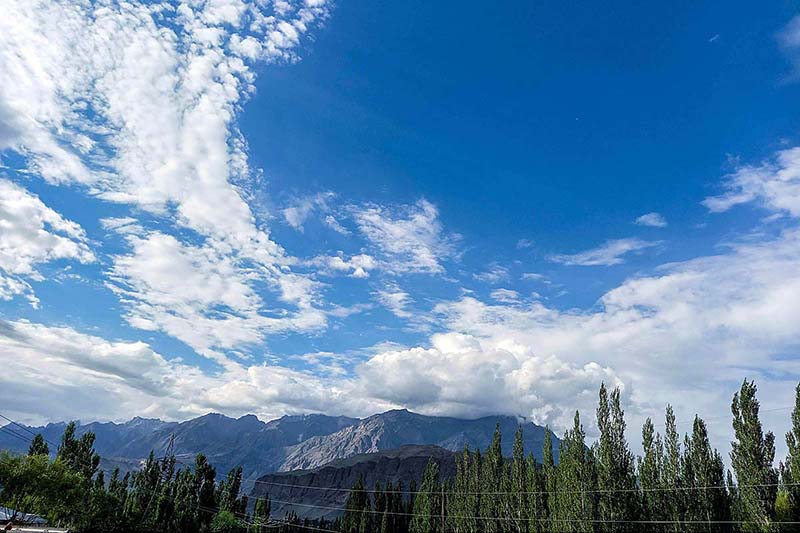 An attractive view of thick clouds hovering over the sky and mountain of the city