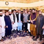 Caretaker Prime Minister Anwaar-ul-Haq Kakar in a group photo with a delegation from his native village Kaan Mehtarzai