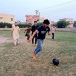 Youngsters are playing football in a local ground