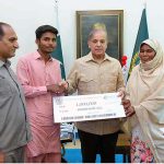 Prime Minister Muhammad Shehbaz Sharif presenting a cheque of 1 million rupees to Jamshed Ali in recognition of his exceptional performance by securing the first position in Matriculation Examination 2023 in Gujranwala Board