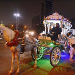 A family enjoying ride in decorated victoria horse cart.