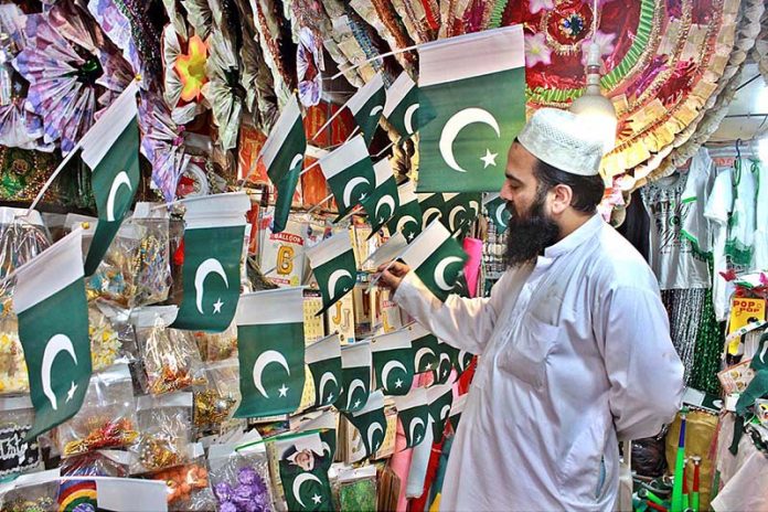 Vendor displaying national flags for attracting customers on the occasion of first August Vendor displaying national flags for attracting customers on the occasion of first August