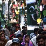 Vendors displaying national flags and other stuff to attract the customers in connection with upcoming Independence Day celebrations at Urdu Bazar