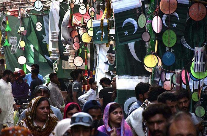 Vendors displaying national flags and other stuff to attract the customers in connection with upcoming Independence Day celebrations at Urdu Bazar Vendors displaying national flags and other stuff to attract the customers in connection with upcoming Independence Day celebrations at Urdu Bazar
