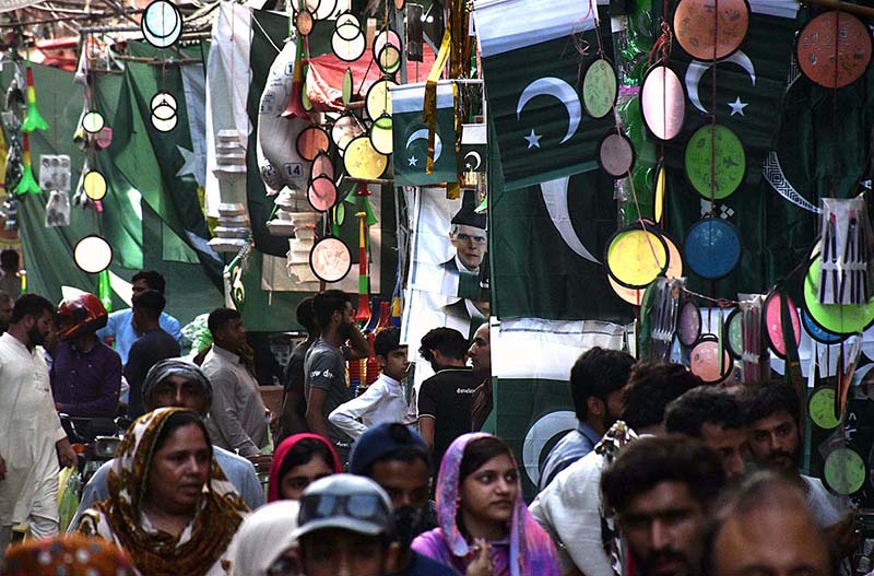 Vendors displaying national flags and other stuff to attract the customers in connection with upcoming Independence Day celebrations at Urdu Bazar