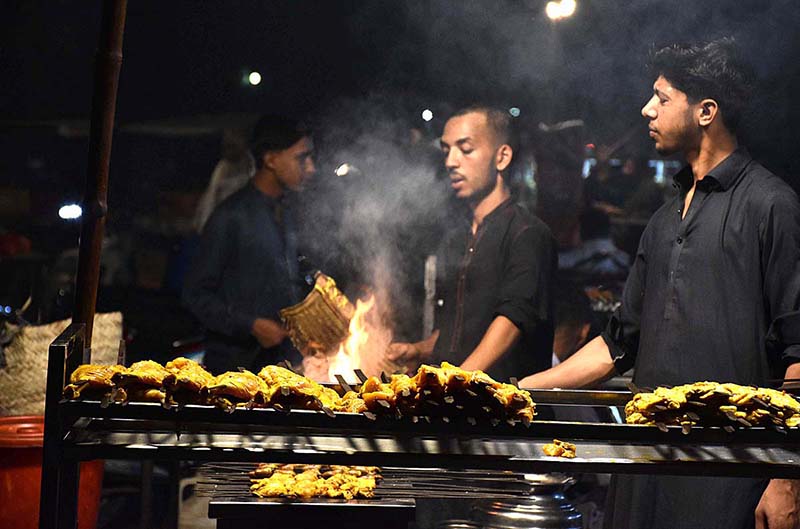 A vendor busy in preparing traditional (Bar-BQ) to the customers on the roadside setup at outside the Railway Station