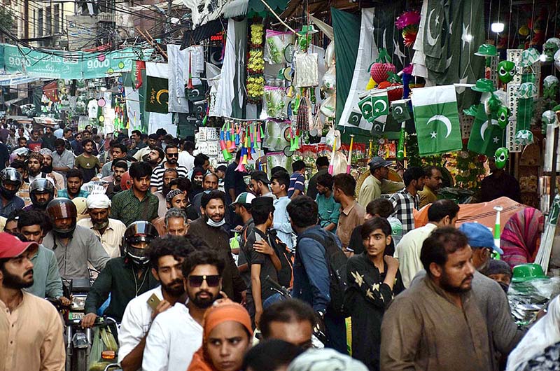 Vendors displaying national flags and other stuff to attract the customers in connection with upcoming Independence Day celebrations at Urdu Bazar