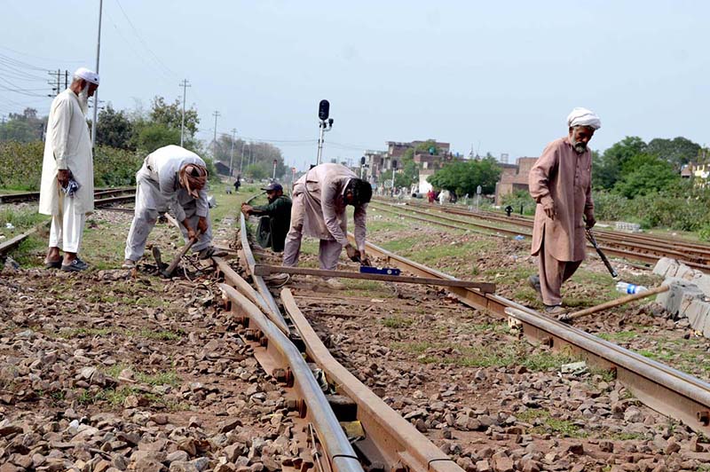 Railway workers are repairing a railway track near Shahdara Railway Station