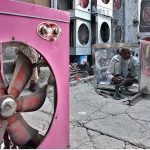 A worker preparing a box for traditional room cooler using sheets of iron at his workshop