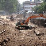 Workers busy construction work of Shahdara fly over during development work in the Provincial Capital.