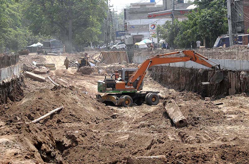 Workers busy construction work of Shahdara fly over during development work in the Provincial Capital.