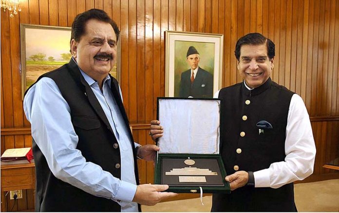 Speaker National Assembly Raja Pervez Ashraf presenting souvenir to Federal Minister for National Food Security, Chaudhary Tariq Bashir Cheema at Parliament House
