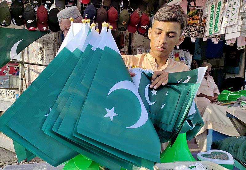 A vendor displaying national flag and other stuff to attract the customers in connection with upcoming Independence Day celebrations