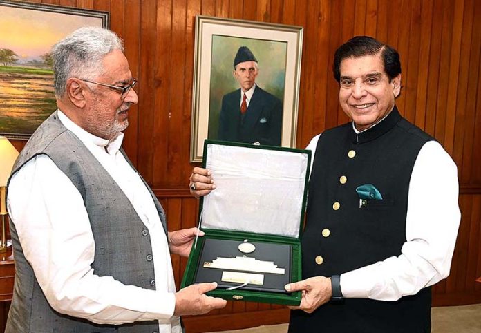 Speaker National Assembly Raja Pervez Ashraf presenting souvenir to Member National Assembly Ghous Bux Mahar at Parliament House