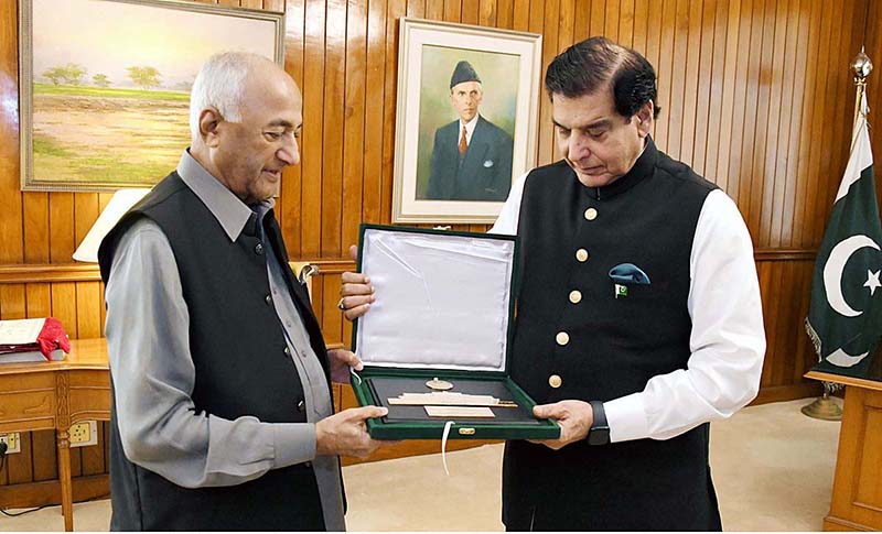Speaker National Assembly Raja Pervez Ashraf presenting souvenir to Member National Assembly, Ali Nawaz Shah at Parliament House