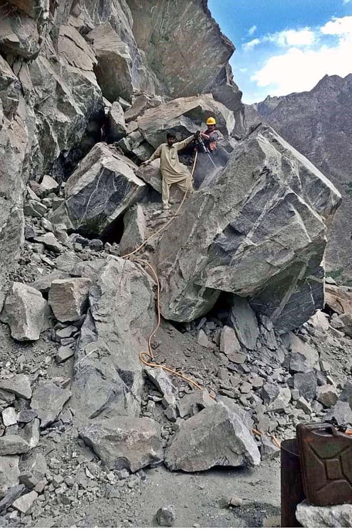 FWO workers busy in clearing block area of Juglote-Skardu road after land sliding during rain in city