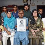 Retired Primary School Teacher Ameer Ali Mungi shows his Guinness World Records Certificate whose whole family member's birth date is August 01