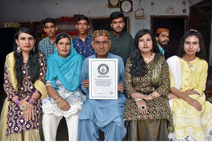 Retired Primary School Teacher Ameer Ali Mungi shows his Guinness World Records Certificate whose whole family member's birth date is August 01