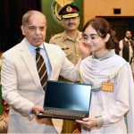 Prime Minister Muhammad Shehbaz Sharif distributing laptops among the children of Martyrs during his visit of General Headquarters