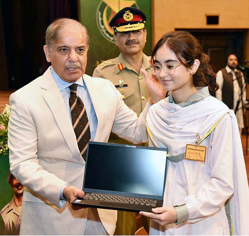 Prime Minister Muhammad Shehbaz Sharif distributing laptops among the children of Martyrs during his visit of General Headquarters