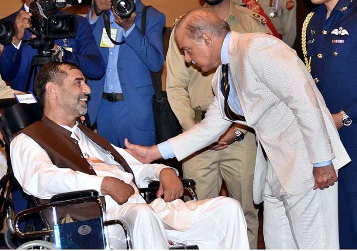 Prime Minister Muhammad Shehbaz Sharif interacting with families of Martyrs during his visit of General Prime Minister Muhammad Shehbaz Sharif interacting with families of Martyrs during his visit of General