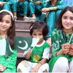 Children, dressed in flag-colored clothing and holding Pakistani flag during Flag hoisting ceremony at Rescue 1122 Headquarter on the occasion of 77th Independence Day celebration