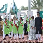 Students performing tableau during a ceremony organized by the City District Government at Ghanta Ghar on the occasion of 77th Independence Day celebration