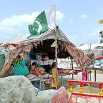 A view of Pakistani flag on the makeshift house on the occasion of 77th Independence Day celebration