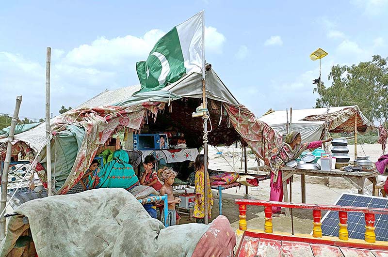 A view of Pakistani flag on the makeshift house on the occasion of 77th Independence Day celebration
