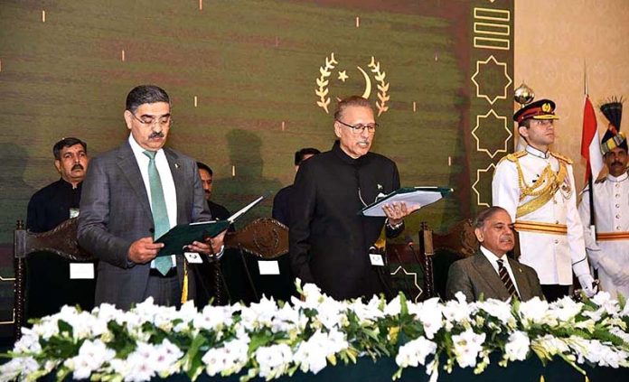 President Dr. Arif Alvi administering the oath of office to Anwar-ul-Haq Kakar as the Caretaker Prime Minister of Pakistan at an oath-taking ceremony held at Aiwan-e-Sadr