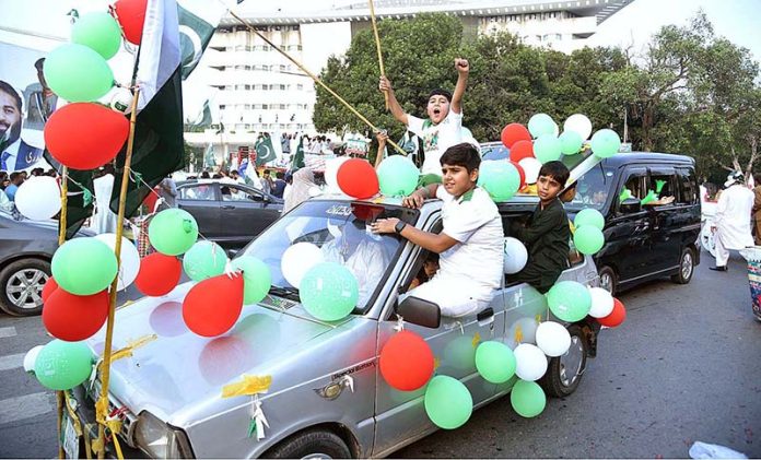 Children enjoying car ride decorated with balloons on the occasion of 77th Independence Day celebration