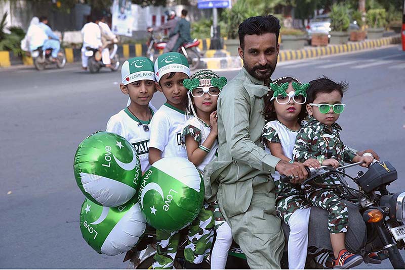 Children enjoying car ride decorated with balloons on the occasion of 77th Independence Day celebration
