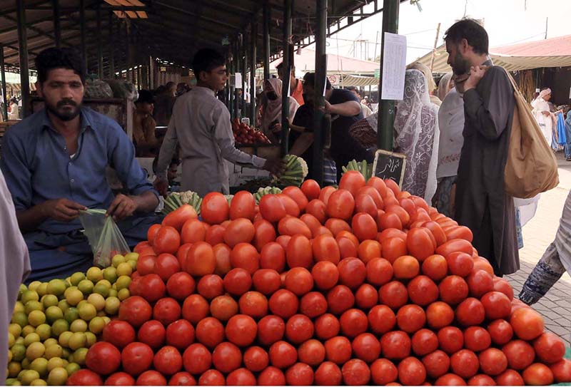 People purchasing vegetables from a stall at Sunday Bazar Peshawar Morr